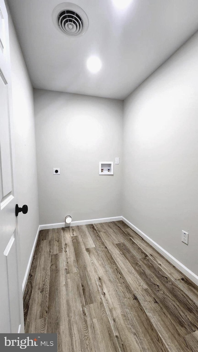 washroom featuring hookup for a washing machine, electric dryer hookup, and wood-type flooring