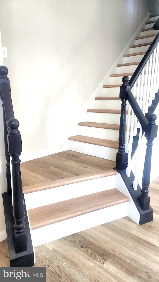 stairway featuring hardwood / wood-style floors