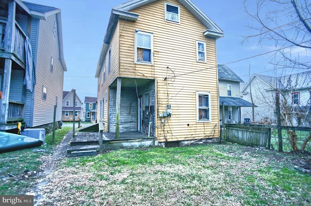 rear view of property featuring a yard