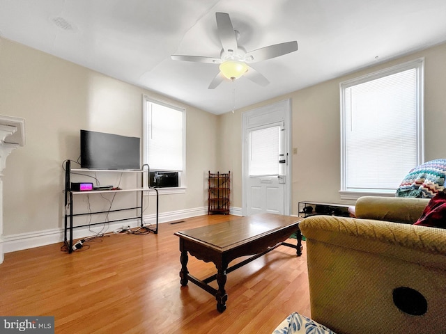 living room featuring light hardwood / wood-style flooring and ceiling fan