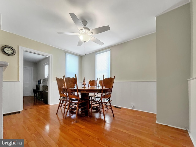 dining room with ceiling fan and wood-type flooring