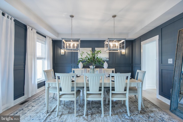 dining room featuring wood-type flooring and a chandelier