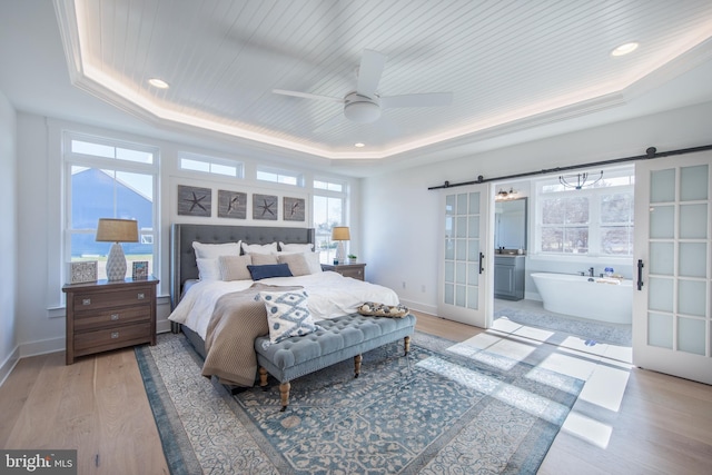 bedroom with ceiling fan, french doors, wooden ceiling, a tray ceiling, and light wood-type flooring