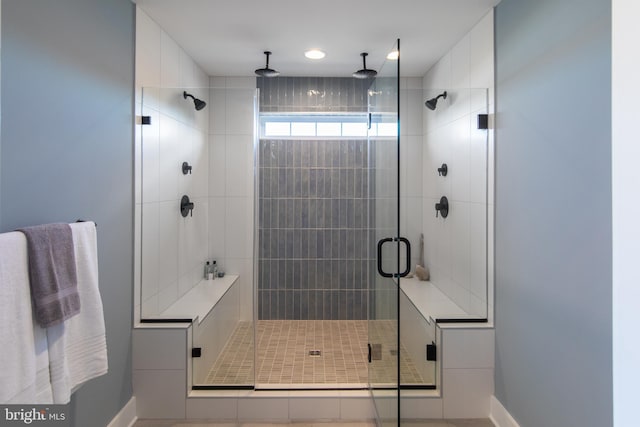 bathroom featuring a shower with shower door