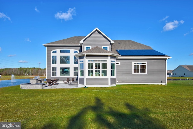 rear view of property featuring a patio area and a yard