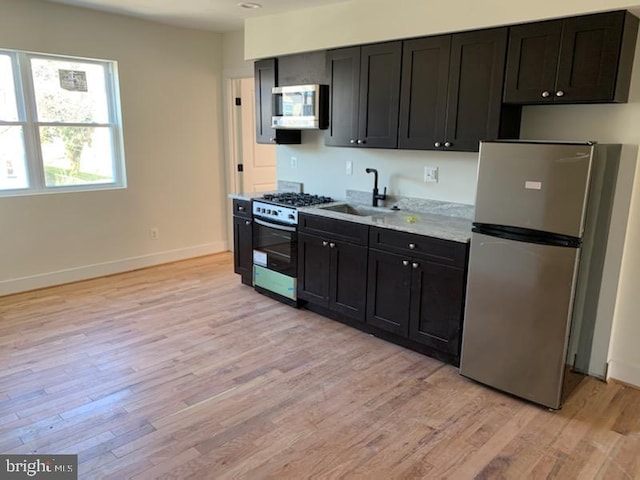 kitchen featuring sink, stainless steel appliances, and light wood-type flooring