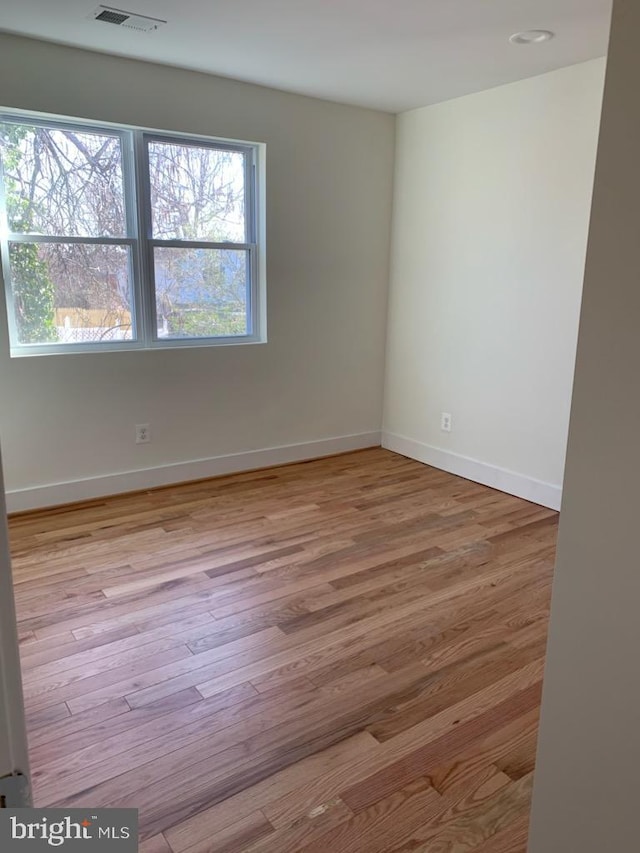 unfurnished room featuring light hardwood / wood-style floors