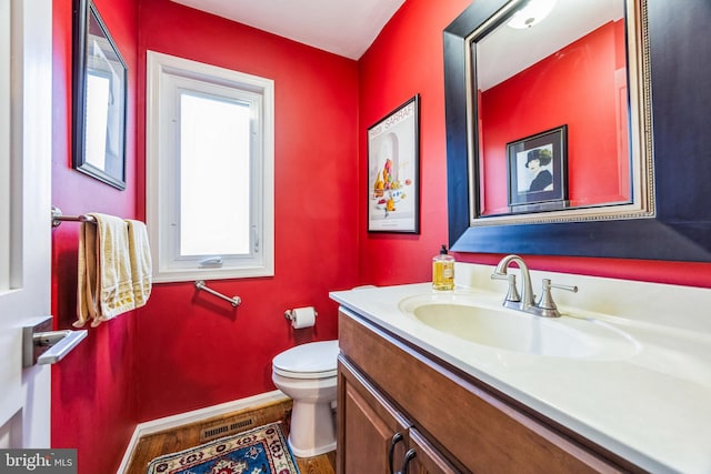 bathroom featuring hardwood / wood-style floors, vanity, and toilet