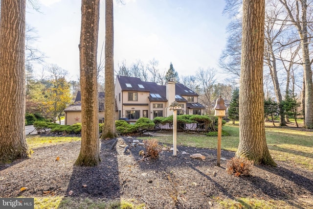 english style home with a front lawn