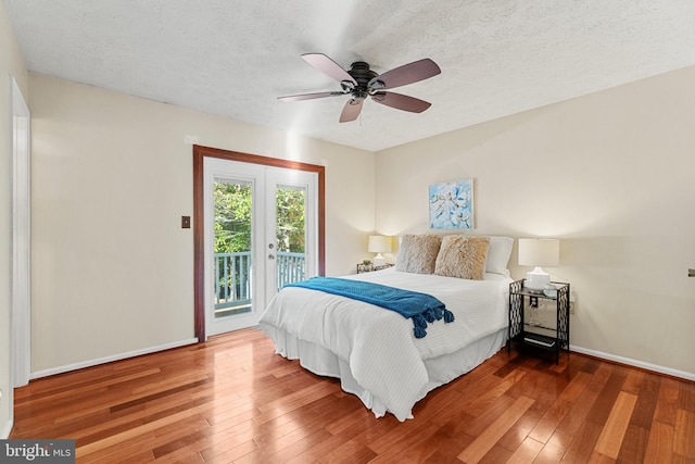 bedroom with access to exterior, ceiling fan, a textured ceiling, and hardwood / wood-style flooring