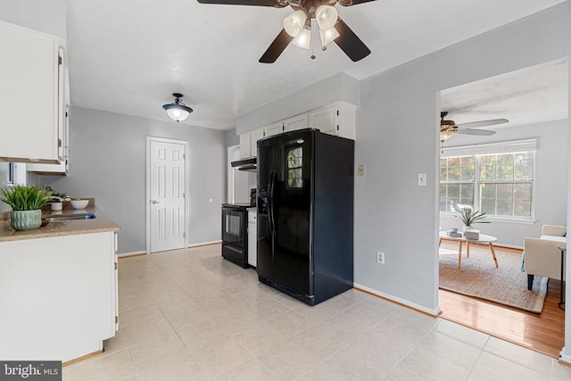 kitchen featuring white cabinetry, light tile patterned flooring, black appliances, and ceiling fan