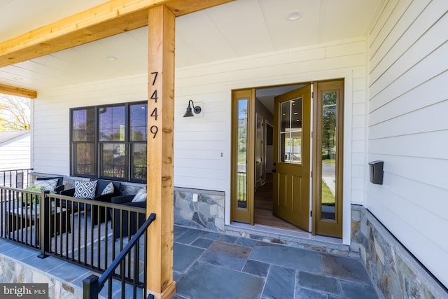 view of exterior entry with a porch