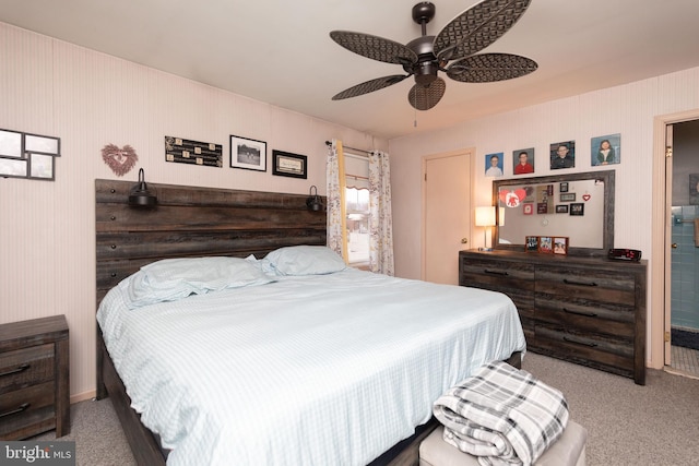 bedroom featuring light colored carpet, ensuite bath, and ceiling fan