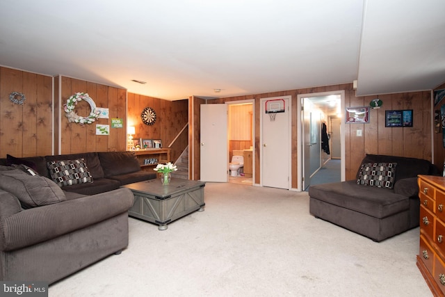 living room featuring carpet floors and wood walls