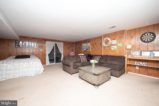 living room featuring carpet and wooden walls