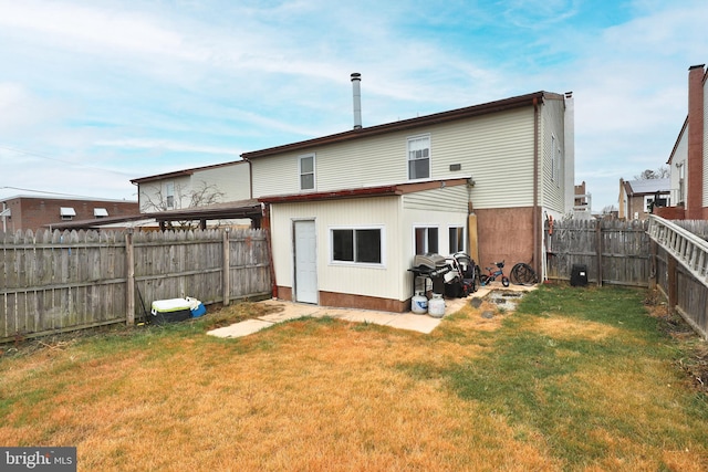 rear view of property with a lawn