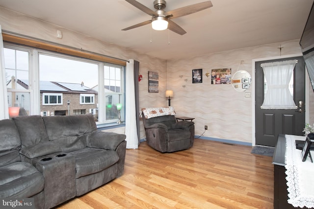 living room featuring ceiling fan and light wood-type flooring