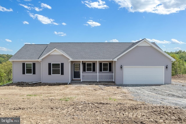 single story home with a porch and a garage