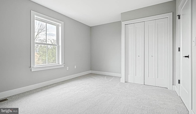 unfurnished bedroom featuring a closet and carpet