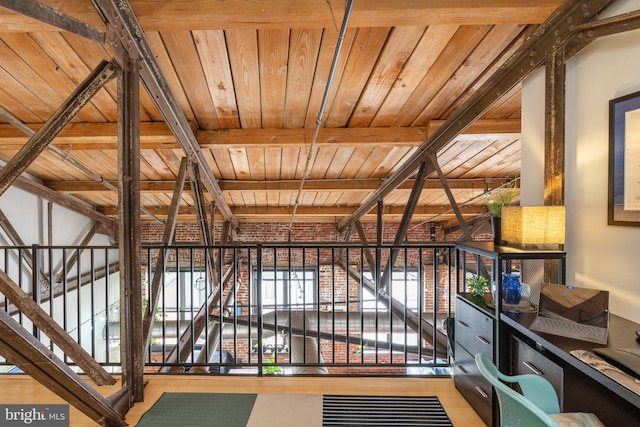 corridor featuring beam ceiling, wood-type flooring, and wooden ceiling