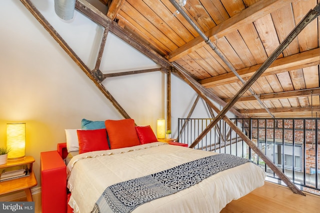 bedroom with hardwood / wood-style flooring, lofted ceiling with beams, and wooden ceiling