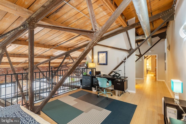 home office featuring lofted ceiling with beams, wooden ceiling, and wood-type flooring