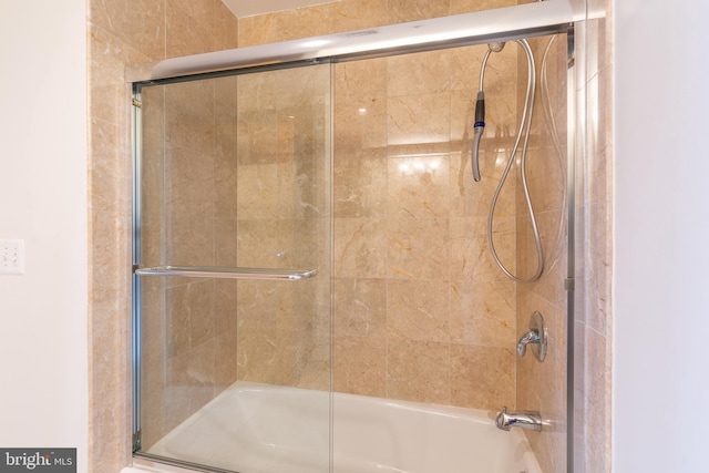 bathroom featuring combined bath / shower with glass door