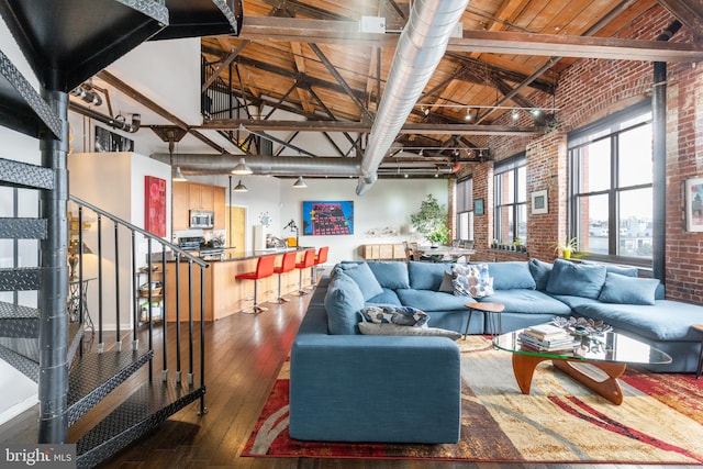 living room with beam ceiling, dark hardwood / wood-style flooring, high vaulted ceiling, and wood ceiling