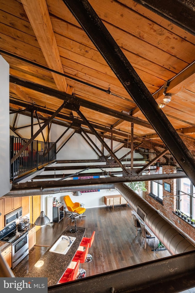 interior space featuring vaulted ceiling with beams, hardwood / wood-style floors, wood ceiling, and track lighting