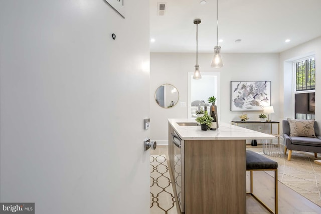 kitchen with a kitchen island, sink, a kitchen bar, hanging light fixtures, and stainless steel dishwasher