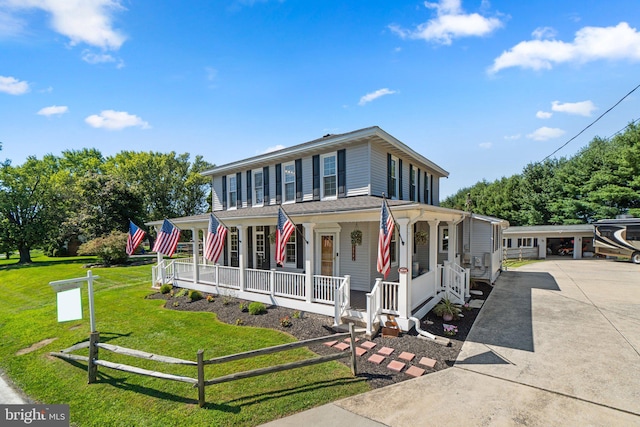 view of front facade featuring a carport, covered porch, and a front yard