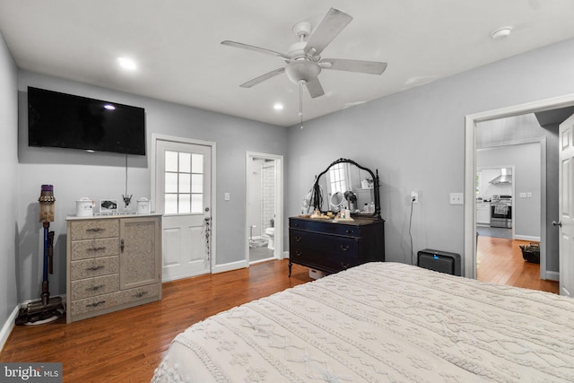 bedroom with hardwood / wood-style floors, ceiling fan, and ensuite bathroom