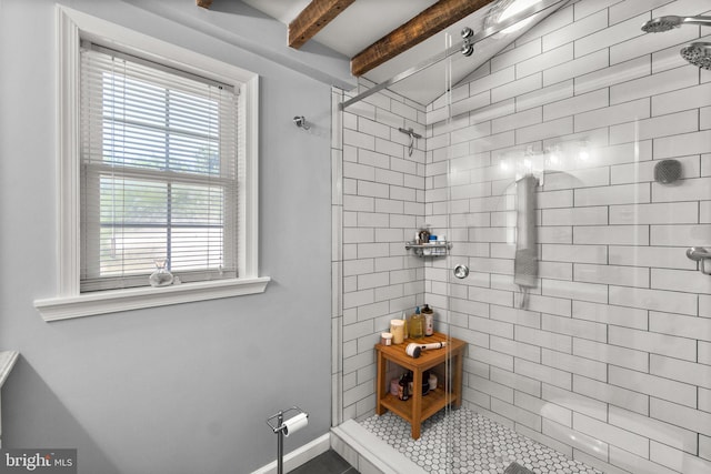 bathroom featuring vaulted ceiling with beams and an enclosed shower