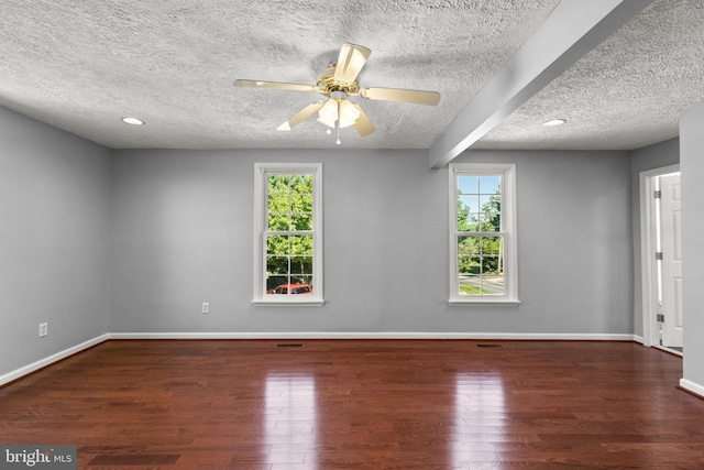 spare room with a textured ceiling, dark hardwood / wood-style floors, and ceiling fan