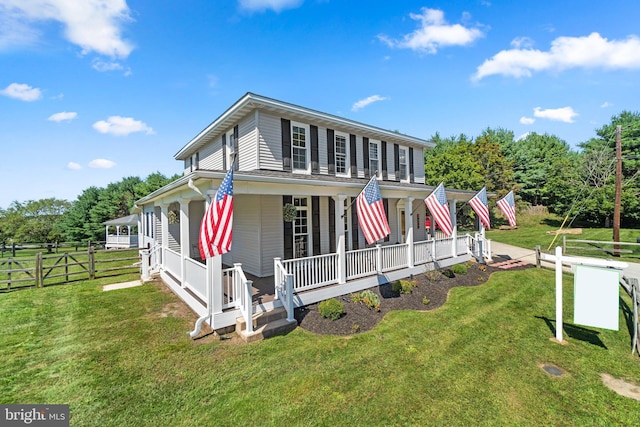 view of front of property with a porch and a front yard