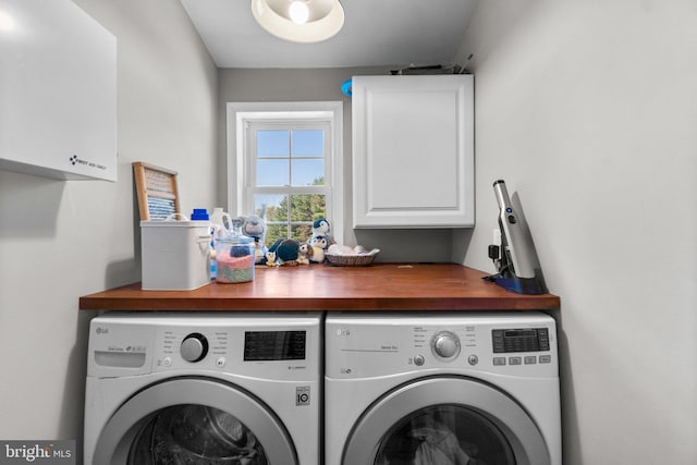 laundry room featuring cabinets and washing machine and dryer