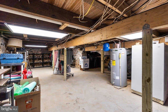 basement with white fridge and electric water heater