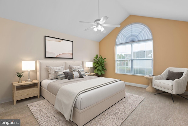 bedroom with ceiling fan, light carpet, and vaulted ceiling