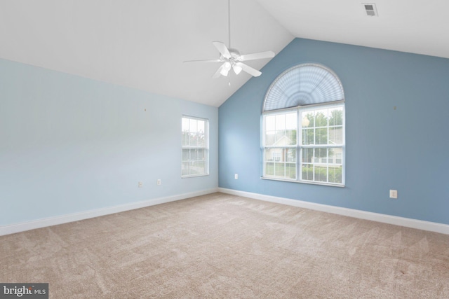 unfurnished room with light colored carpet, vaulted ceiling, and ceiling fan