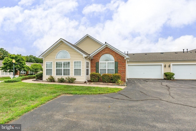 view of front of property with a garage and a front lawn