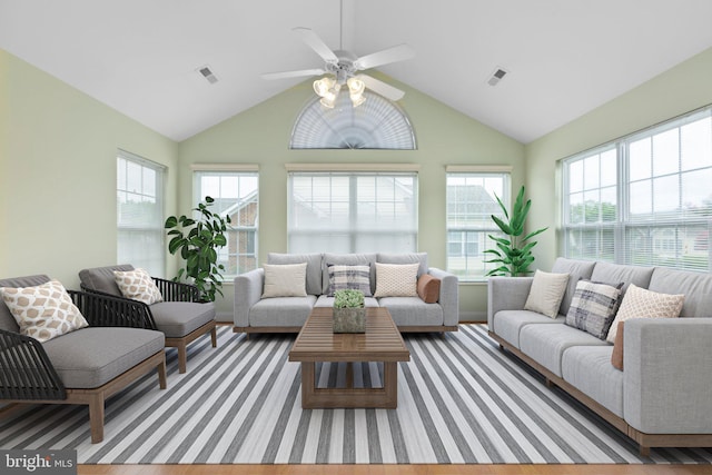 living room featuring ceiling fan, hardwood / wood-style floors, and high vaulted ceiling