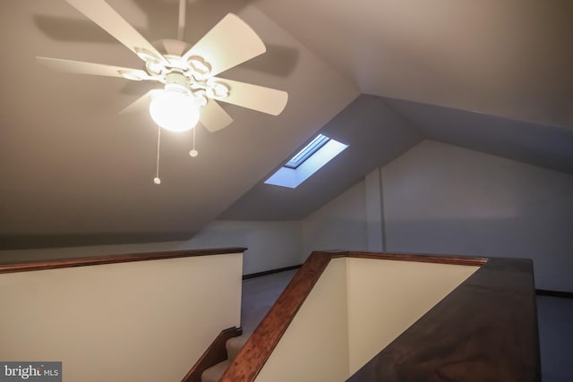 additional living space featuring ceiling fan and vaulted ceiling with skylight