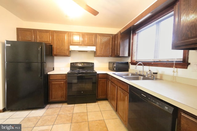 kitchen with sink, light tile patterned floors, and black appliances