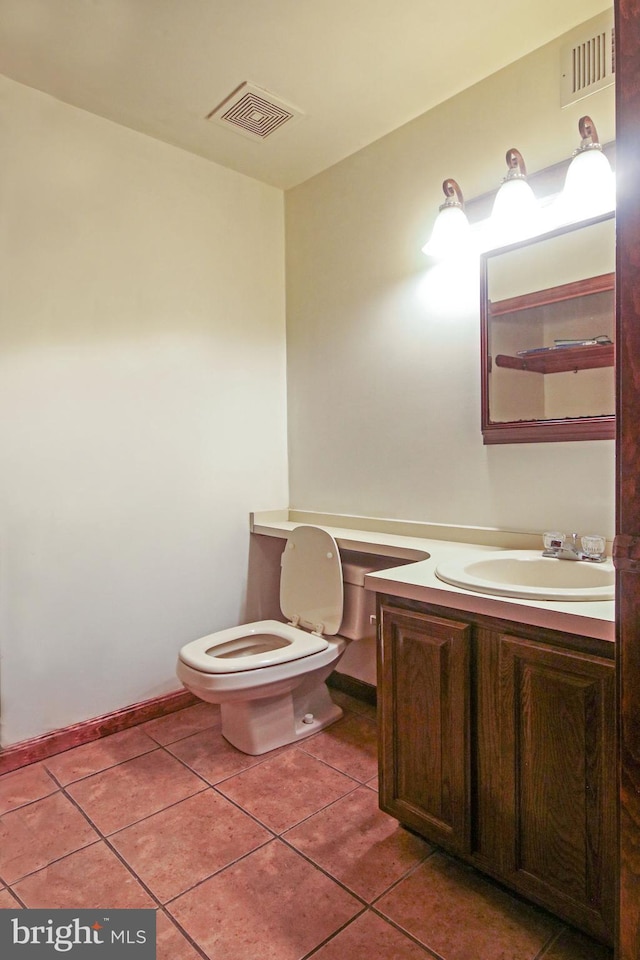 bathroom with tile patterned floors, vanity, and toilet