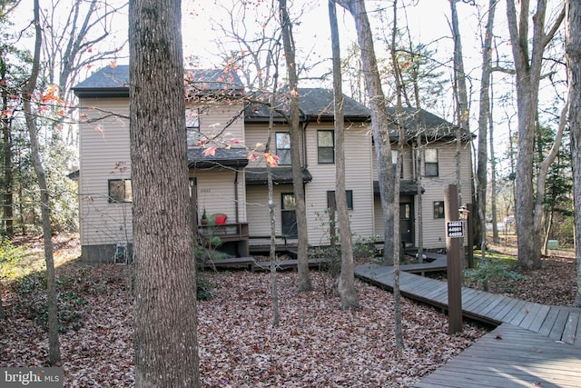 rear view of house with a wooden deck