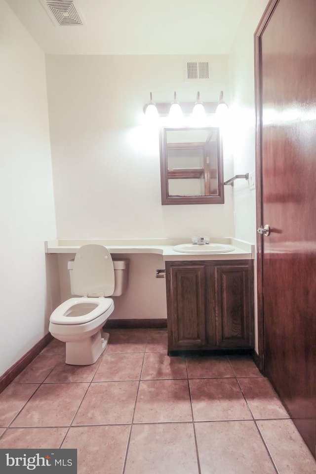 bathroom with tile patterned floors, vanity, and toilet