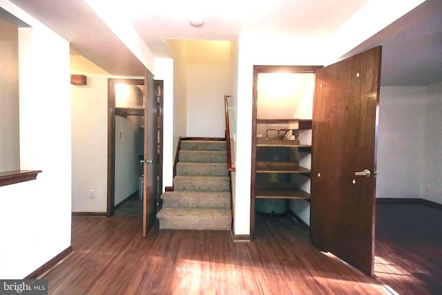 stairs featuring hardwood / wood-style floors