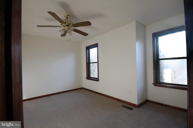 unfurnished room with ceiling fan and light colored carpet