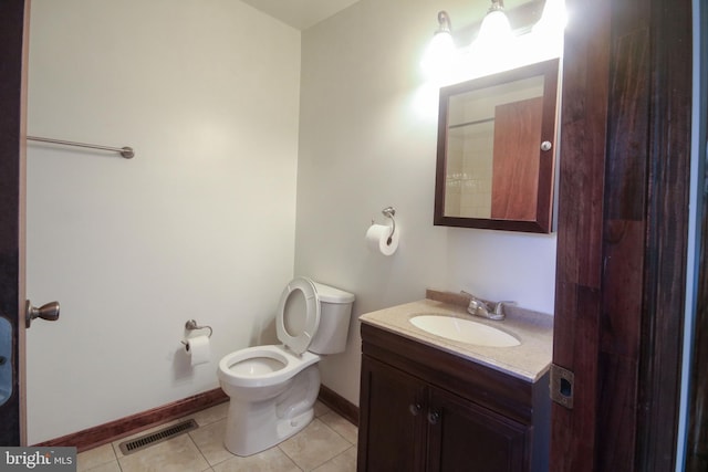 bathroom featuring toilet, vanity, and tile patterned floors