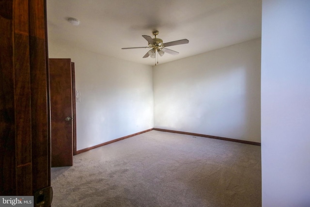 unfurnished room featuring ceiling fan and light carpet